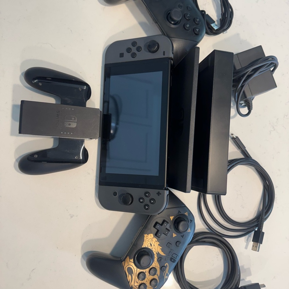 Nintendo Switch w/ 2 Pro controllers and all necessary chargers and wires.